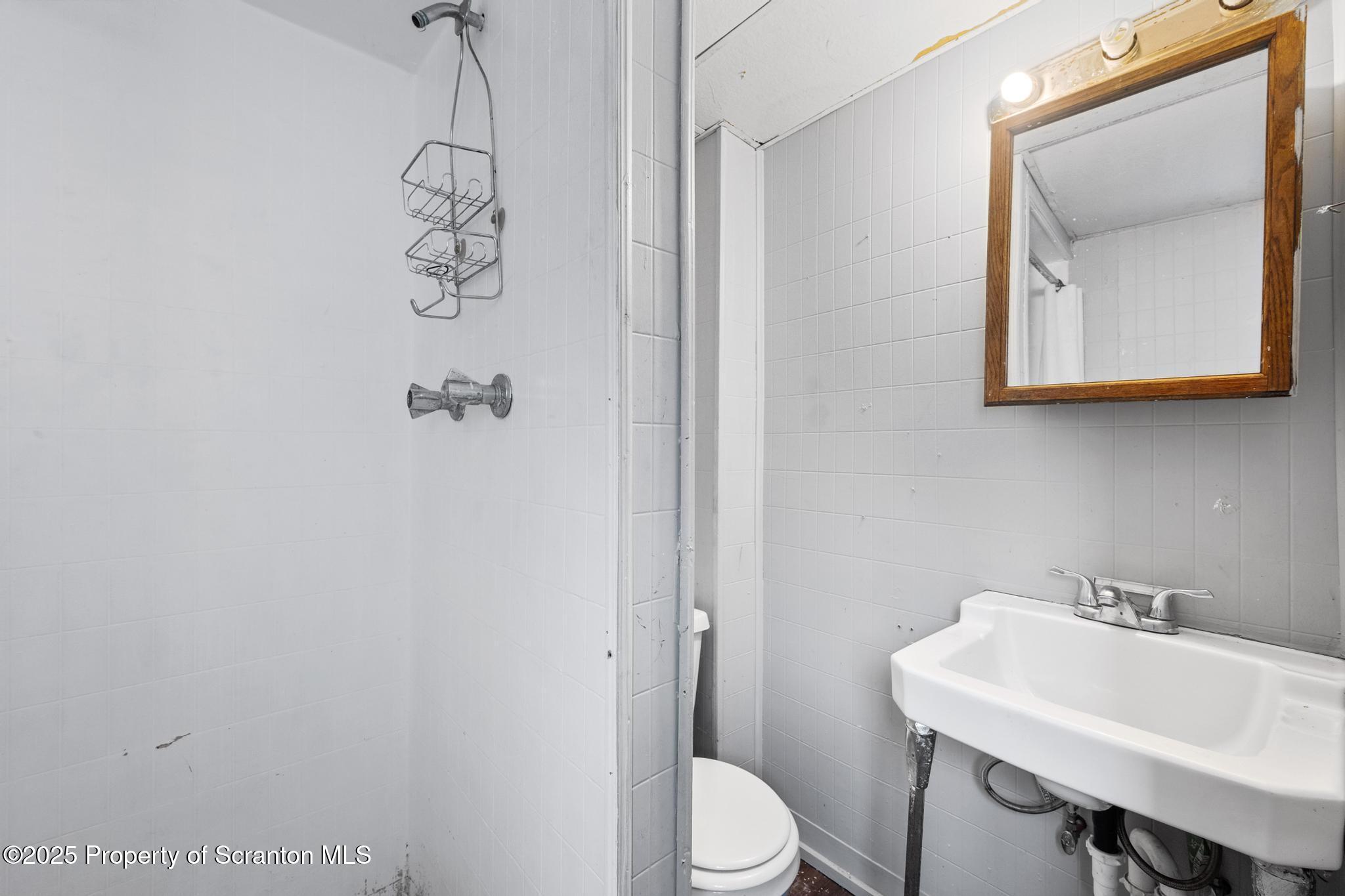 729 Moltke Avenue Scranton, PA 18505 - Photo 30 of 43 a bathroom with a toilet a sink and mirror