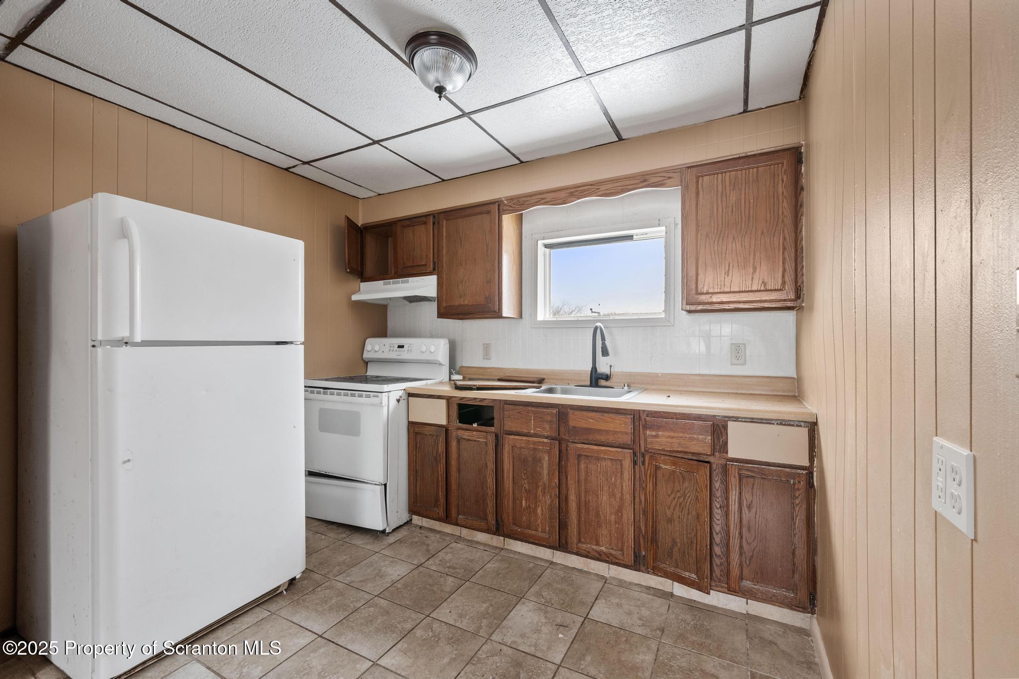 729 Moltke Avenue Scranton, PA 18505 - Photo 34 of 43 a kitchen with a refrigerator sink and cabinets