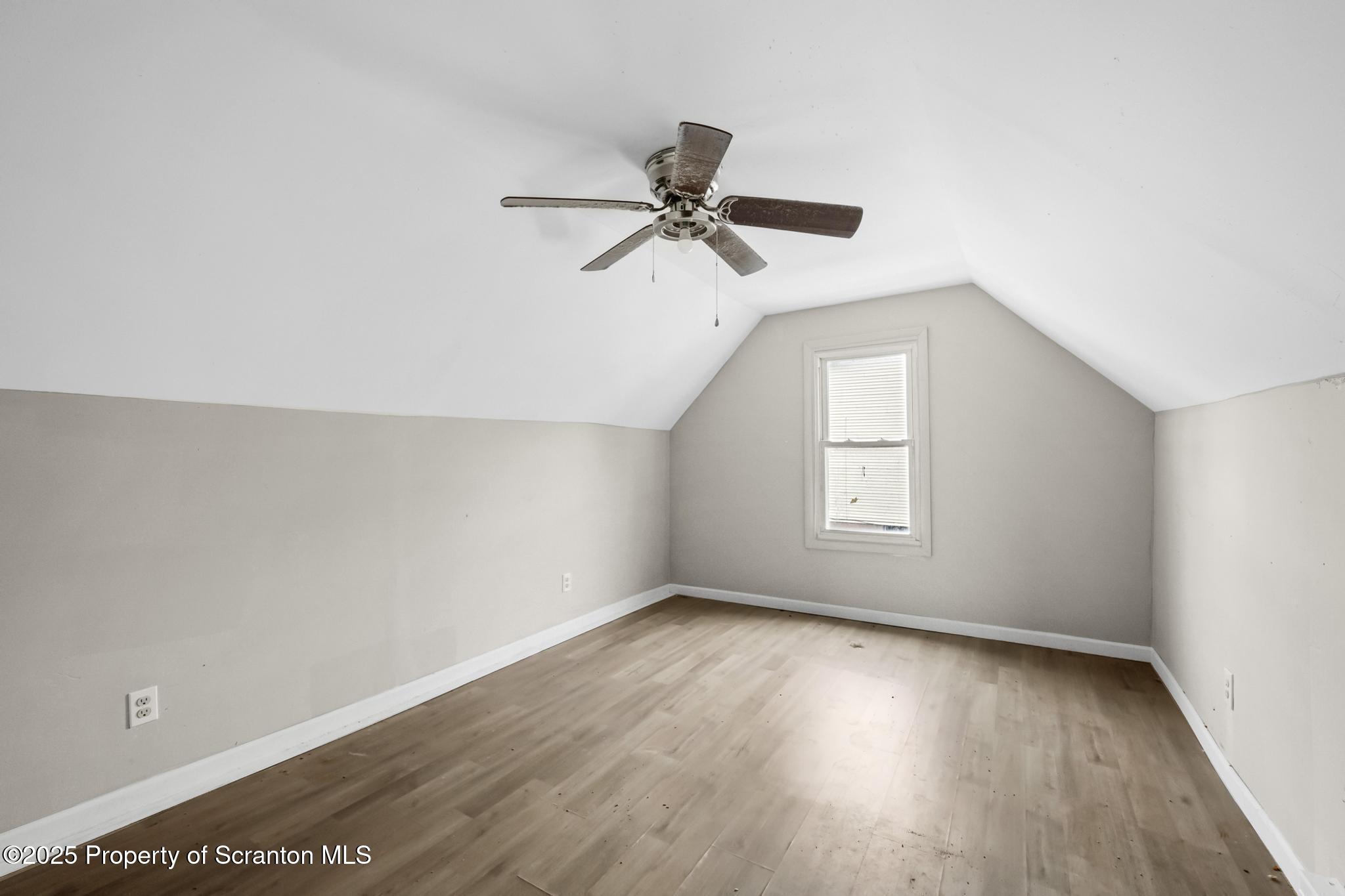 729 Moltke Avenue Scranton, PA 18505 - Photo 42 of 43 an empty room with wooden floor ceiling fan and windows