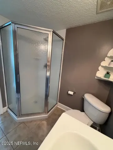 a city view from a balcony with outdoor seating