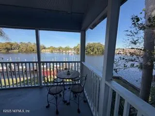 a view of a two chairs and table in the balcony