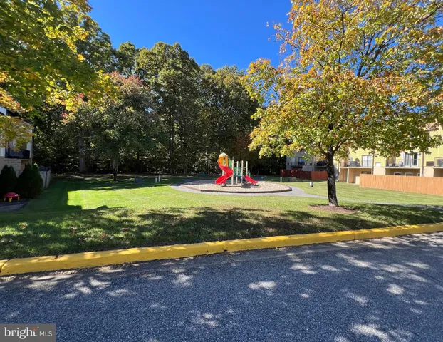 a view of swimming pool with a yard and green space