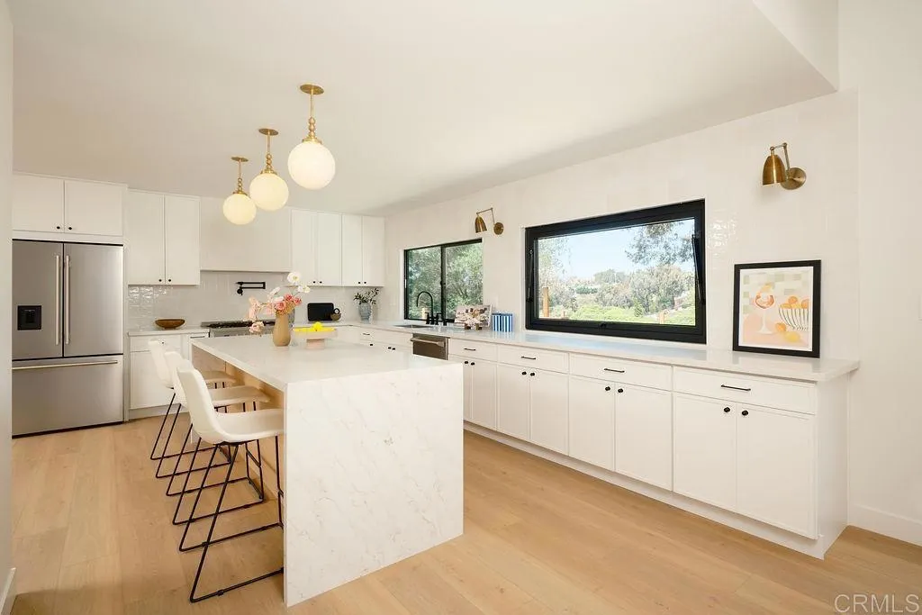 2025 Valley Road Oceanside, CA 92056 - Photo 11 of 31 a kitchen with white cabinets and stainless steel appliances