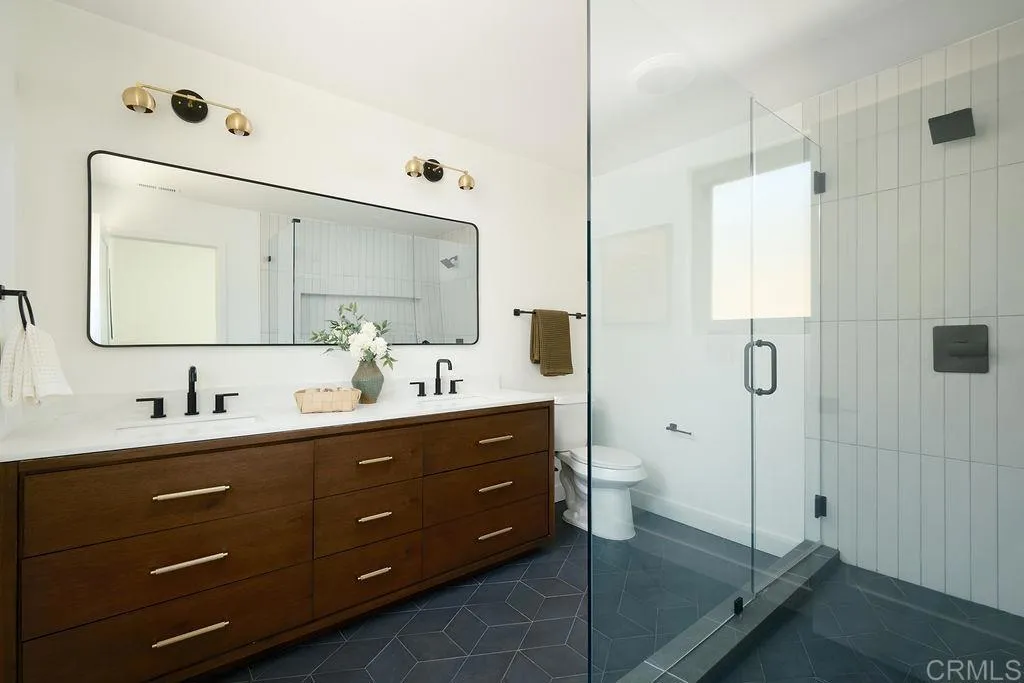 2025 Valley Road Oceanside, CA 92056 - Photo 14 of 31 a bathroom with a double vanity sink toilet and mirror