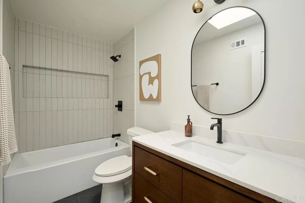 2025 Valley Road Oceanside, CA 92056 - Photo 16 of 31 a bathroom with a sink a toilet and a mirror
