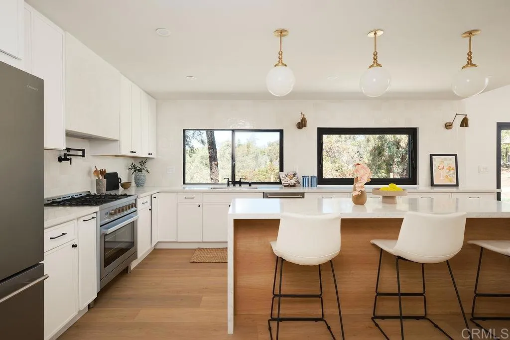 2025 Valley Road Oceanside, CA 92056 - Photo 6 of 31 a kitchen with stainless steel appliances a white cabinets stove and sink