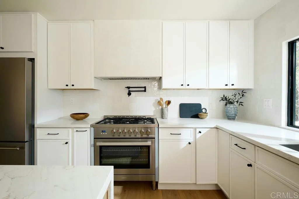 2025 Valley Road Oceanside, CA 92056 - Photo 7 of 31 a kitchen with cabinets appliances and a counter space