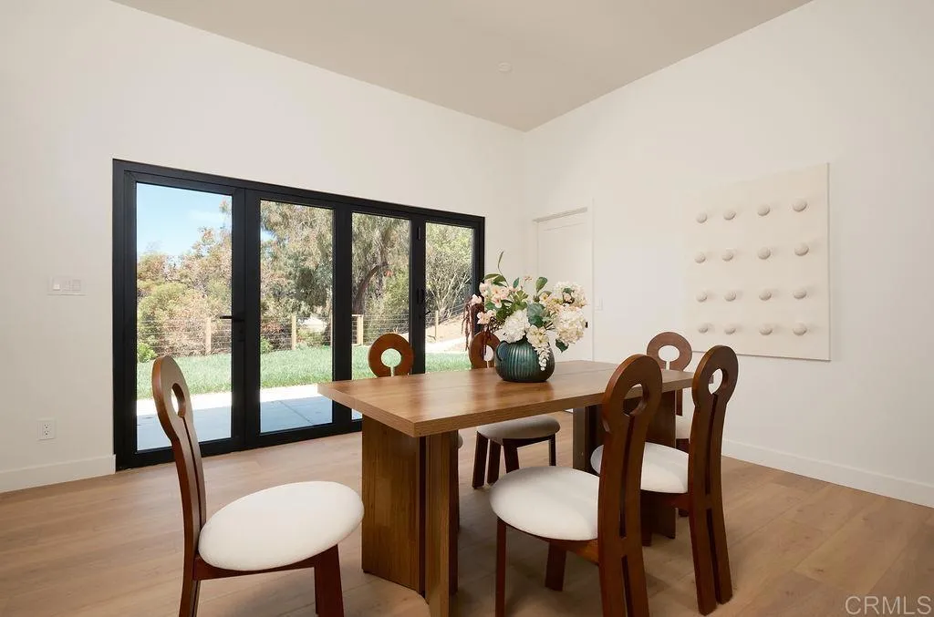 2025 Valley Road Oceanside, CA 92056 - Photo 9 of 31 a dining room with furniture a chandelier and wooden floor