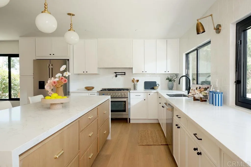 2025 Valley Road Oceanside, CA 92056 - Photo 10 of 31 a kitchen that has a lot of cabinets in it and wooden floors