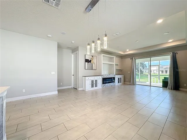 a large kitchen with a large counter top cabinets and stainless steel appliances