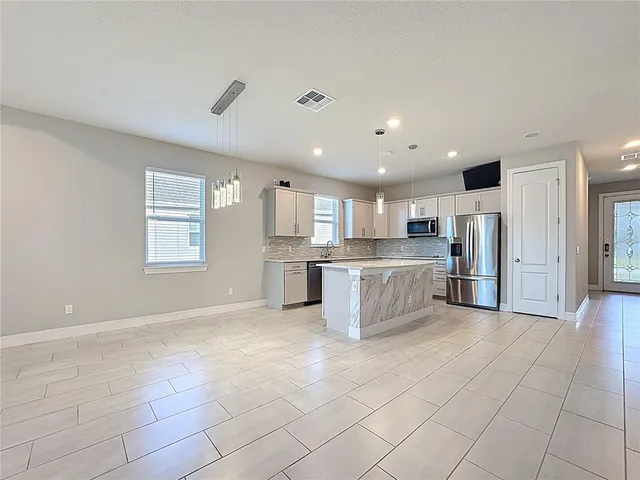 a view of an empty room with glass door
