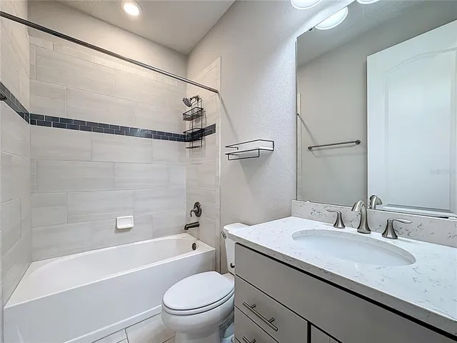 a view of an empty room and a ceiling fan