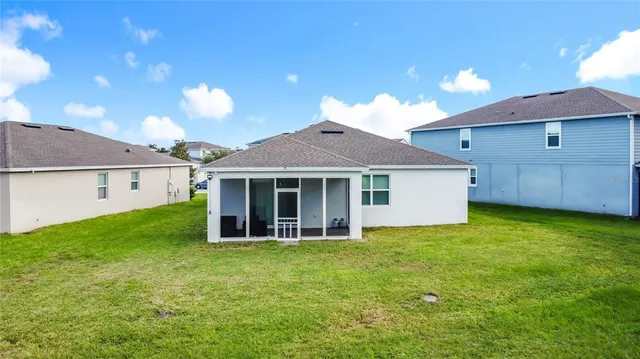 an aerial view of residential houses with outdoor space and a lake view