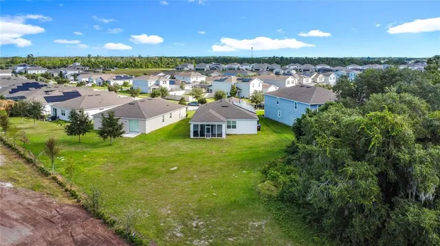 an aerial view of a house with a ocean view