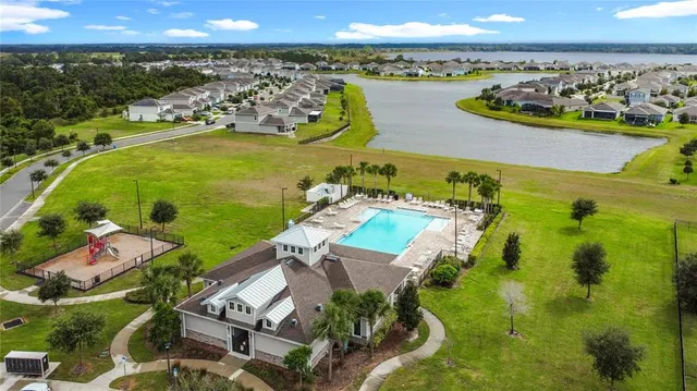 a aerial view of a house with garden space and a patio