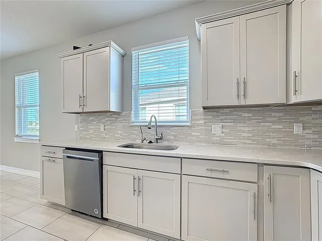 a kitchen with white cabinets