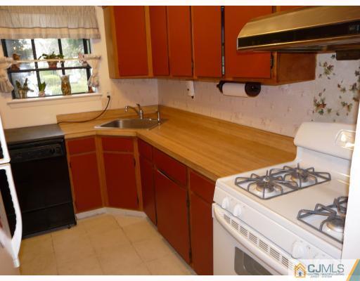 118 Redbud Road Piscataway, NJ 08854 - Photo 3 of 6 a kitchen with stainless steel appliances granite countertop a sink stove and cabinets