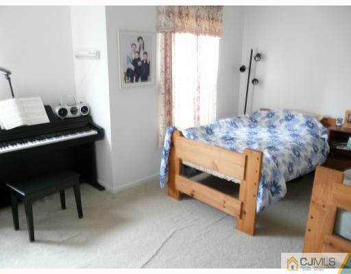 118 Redbud Road Piscataway, NJ 08854 - Photo 5 of 6 a bedroom that has a bed and a table in it