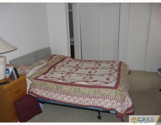 118 Redbud Road Piscataway, NJ 08854 - Photo 6 of 6 a bed sitting in a bedroom next to a cabinet