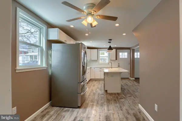 a view of a kitchen with wooden floor and a window