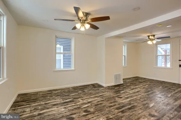 a view of a livingroom with a ceiling fan and window
