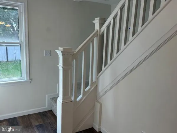 a view of staircase with railing and white walls