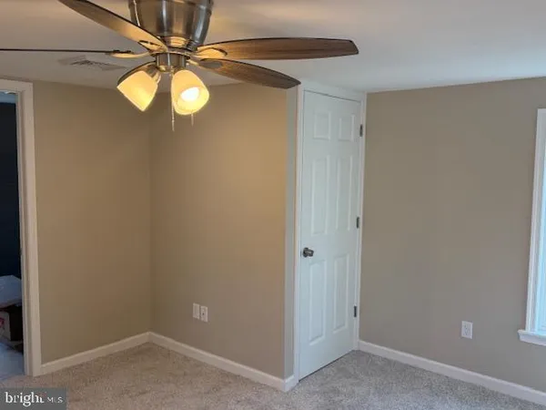 a view of a chandelier fan and window
