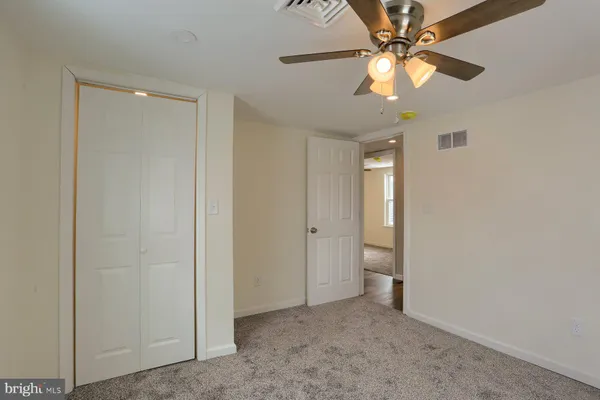 a view of an empty room with a fan