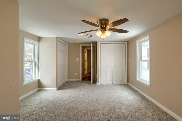a view of house with entryway and wooden floor
