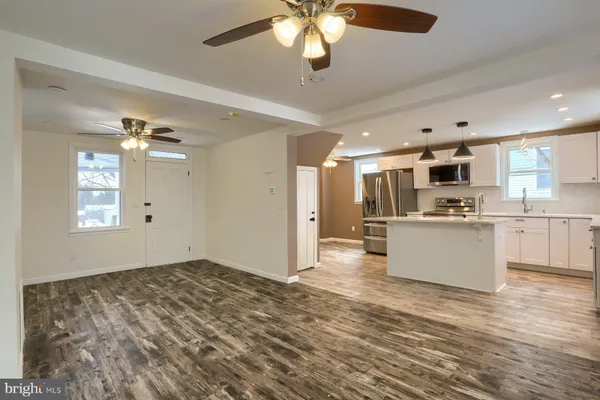 a view of kitchen with sink microwave and refrigerator