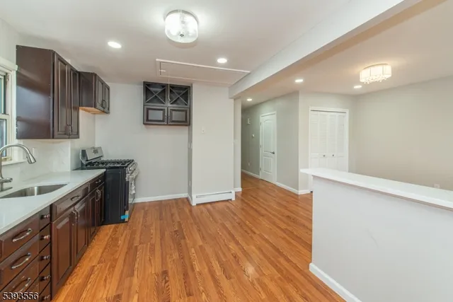 a view of a kitchen with a sink and a refrigerator