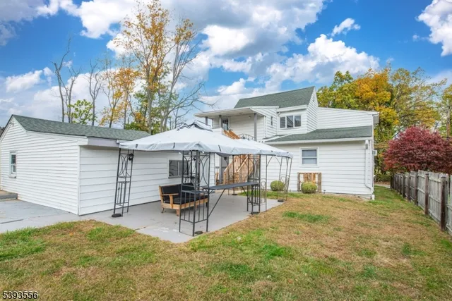 a backyard of a house with table and chairs