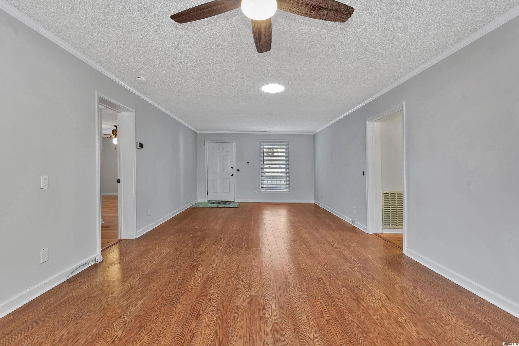1305 Conifer Court Murrells Inlet, SC 29576 - Photo 11 of 30 Unfurnished living room with ceiling fan, light ha