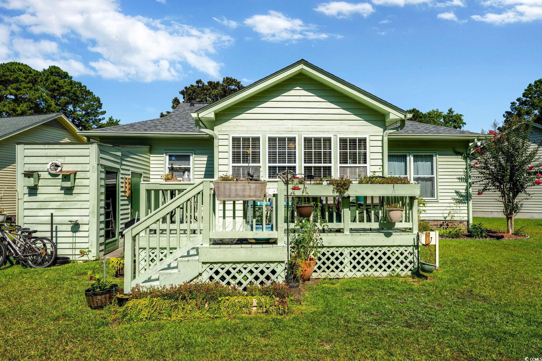 1305 Conifer Court Murrells Inlet, SC 29576 - Photo 19 of 30 View of side of property with a yard and a deck