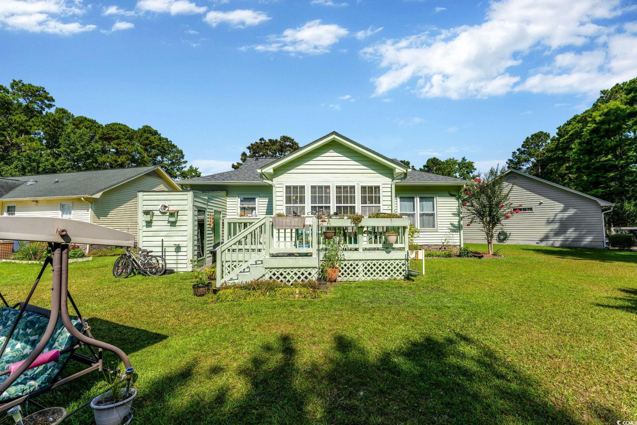 1305 Conifer Court Murrells Inlet, SC 29576 - Photo 20 of 30 Back of house featuring a lawn and a wooden deck