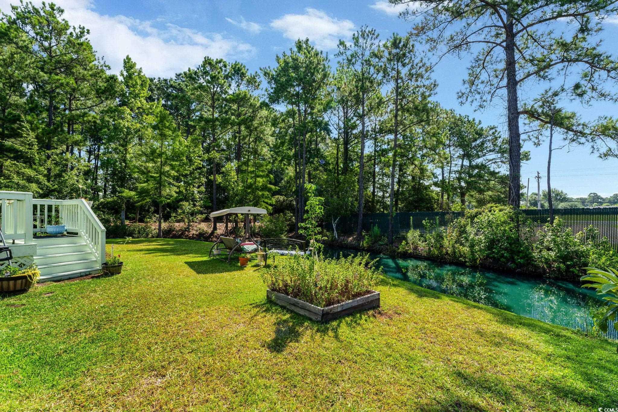 1305 Conifer Court Murrells Inlet, SC 29576 - Photo 23 of 30 View of yard with a deck with water view