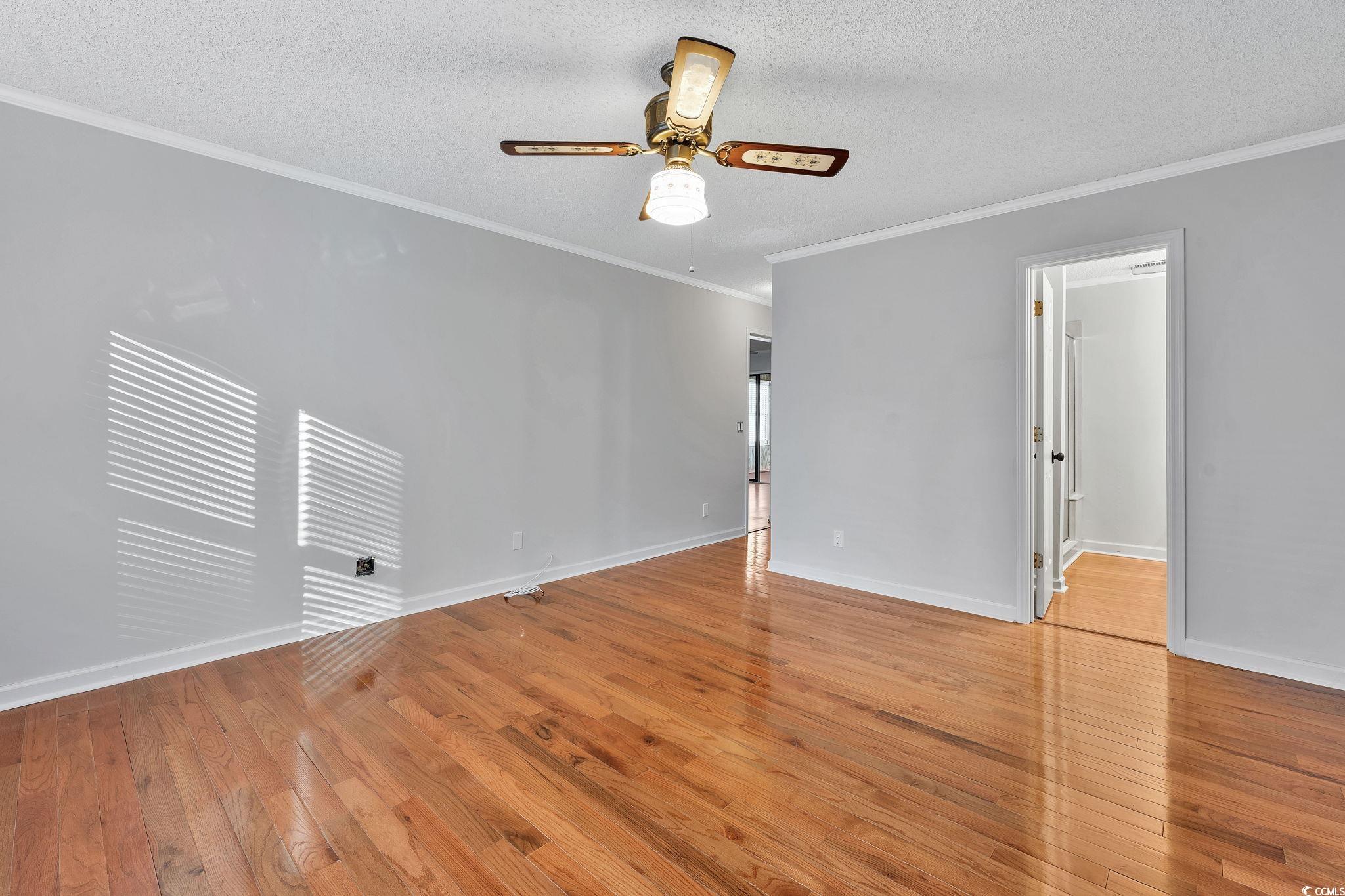 1305 Conifer Court Murrells Inlet, SC 29576 - Photo 9 of 30 Unfurnished room with ceiling fan, light hardwood