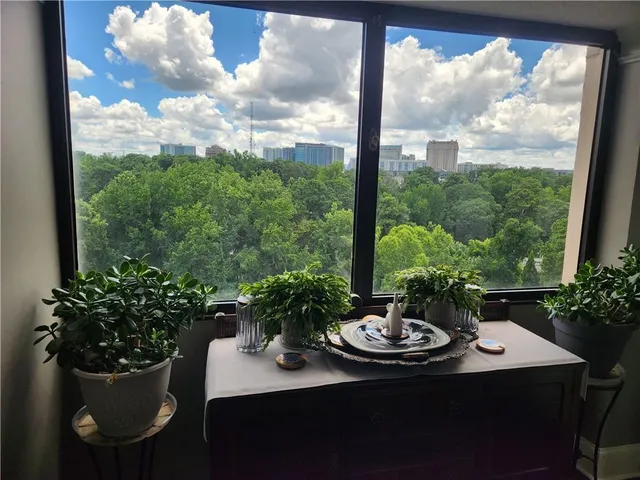 a view of a porch with a dining table and chairs