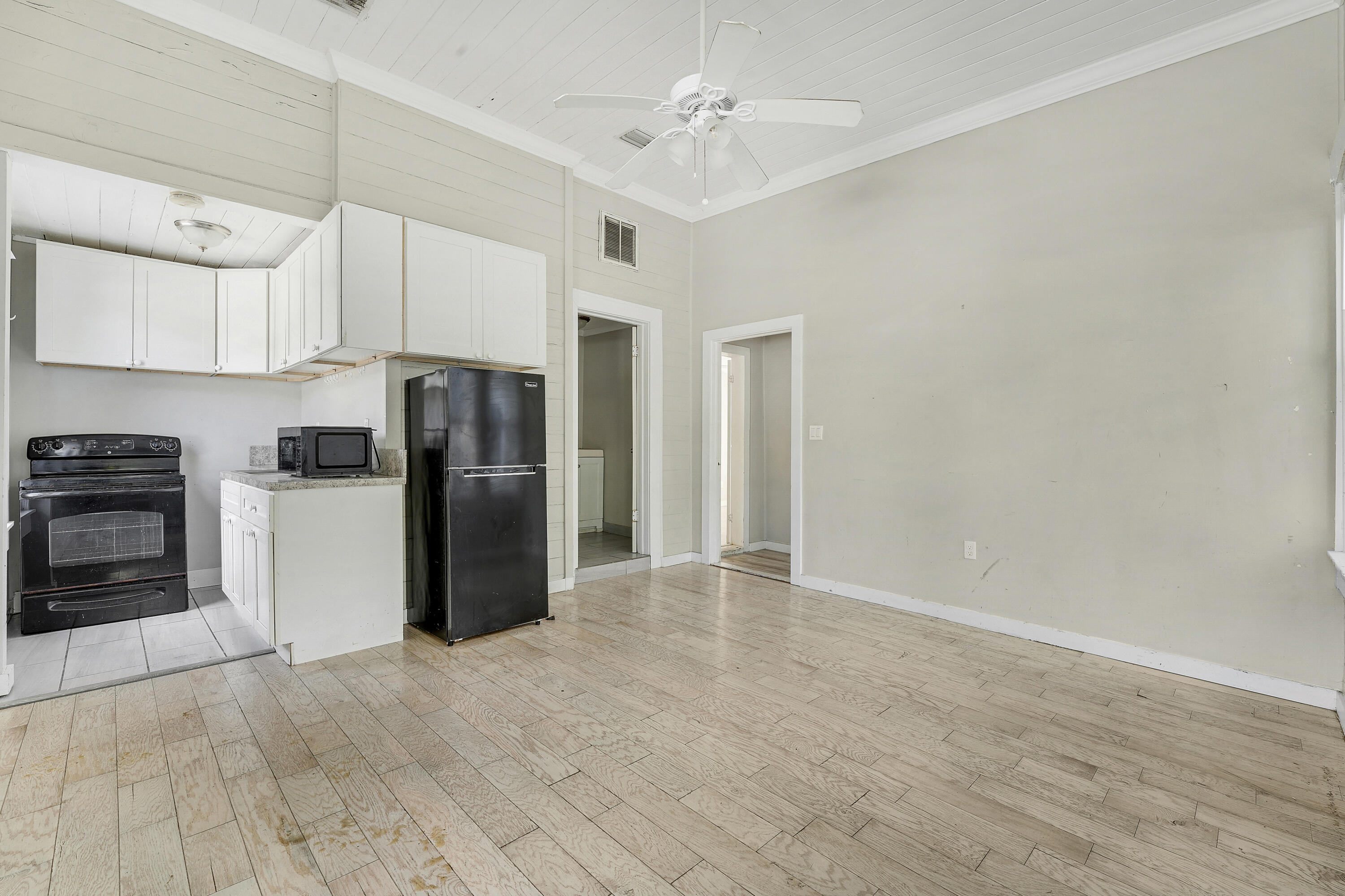 301 South 7th Street Fort Pierce, FL 34950 - Photo 6 of 15 a kitchen with stainless steel appliances a refrigerator and a stove top oven
