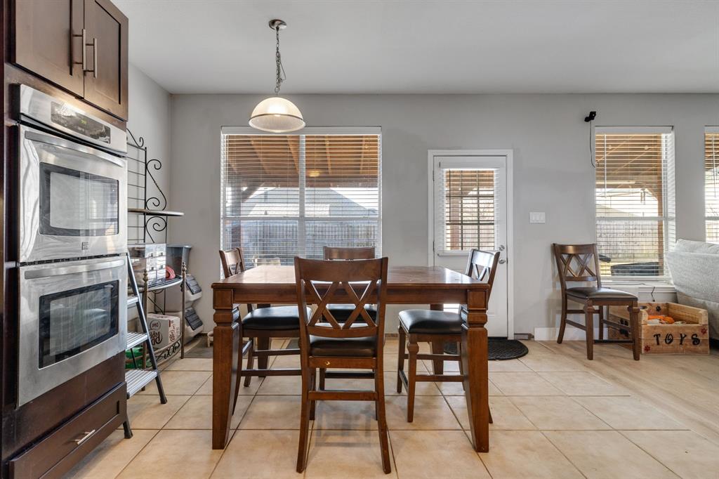 4029 Bridge Water Road Heartland, TX 75126 - Photo 13 of 39 a dining room with furniture a chandelier and window