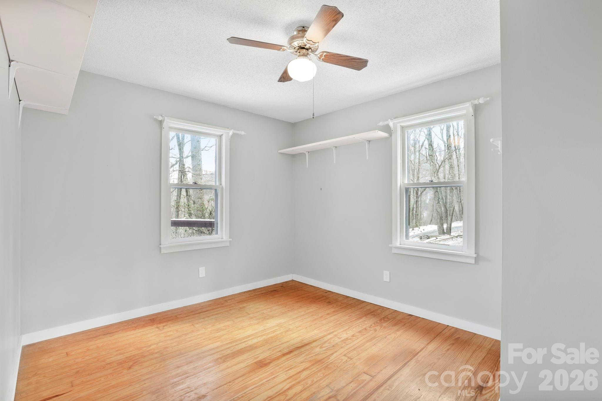 186 Greentree Lane Canton, NC 28716 - Photo 16 of 32 a view of an empty room with a window and wooden floor