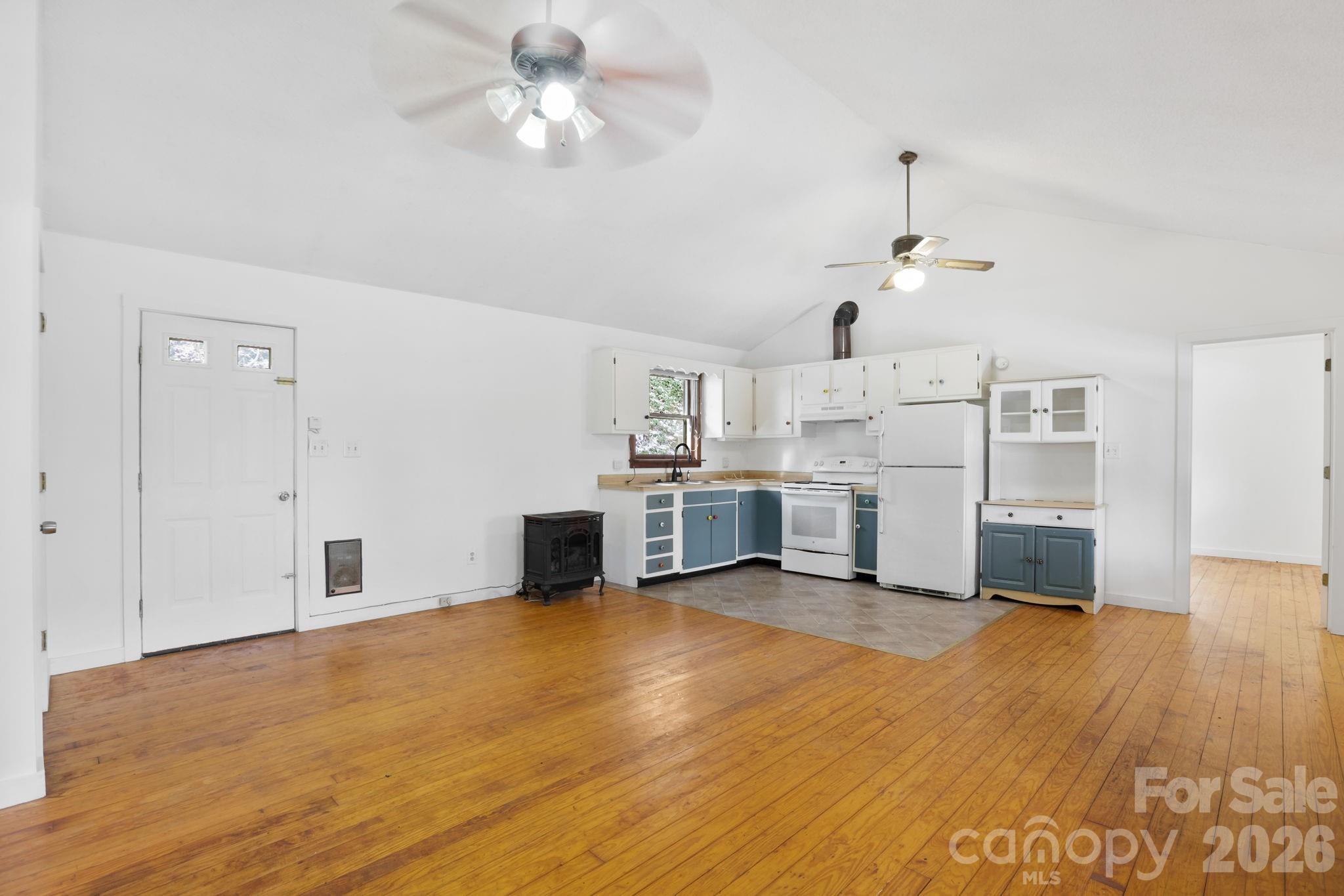 186 Greentree Lane Canton, NC 28716 - Photo 5 of 32 a view of a kitchen with wooden floor electronic appliances and a ceiling fan