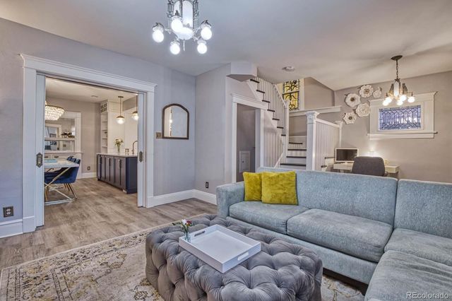 a living room with furniture and a chandelier