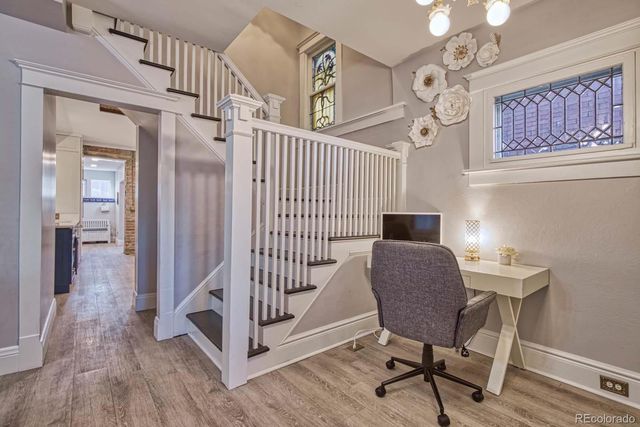 a view of a room with furniture and wooden floor