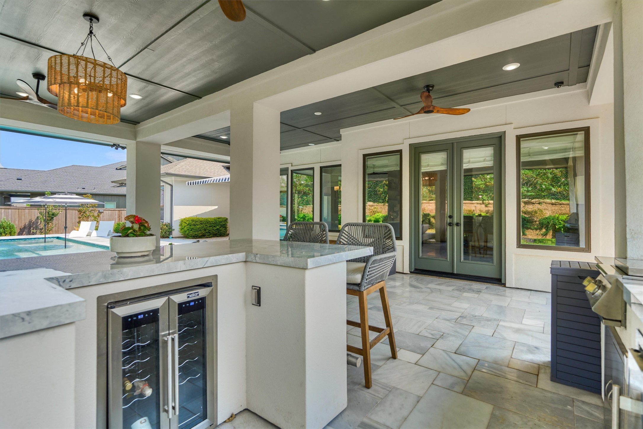 2017 Bennet Lane Conroe, TX 77384 - Photo 41 of 48 Extended covered patio featuring four ceiling fans, providing a comfortable and versatile outdoor living space