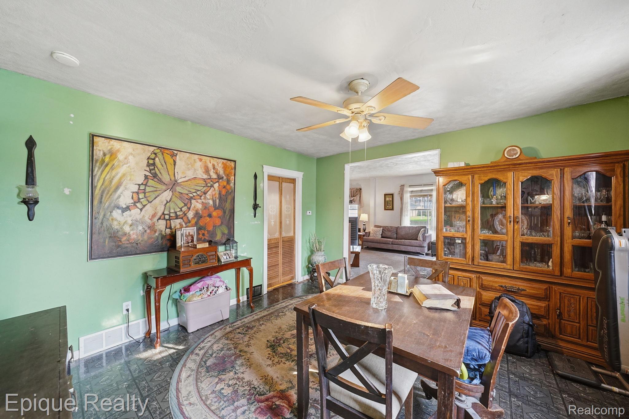 75 East Cicotte Street River Rouge, MI 48218 - Photo 9 of 25 Dining area featuring dark-toned flooring, a light-toned ceiling fan, and an open doorway
