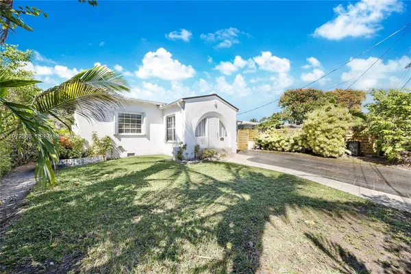 a bathroom with a sink mirror and a yard
