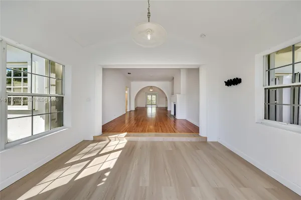 a view of a livingroom with wooden floor and furniture