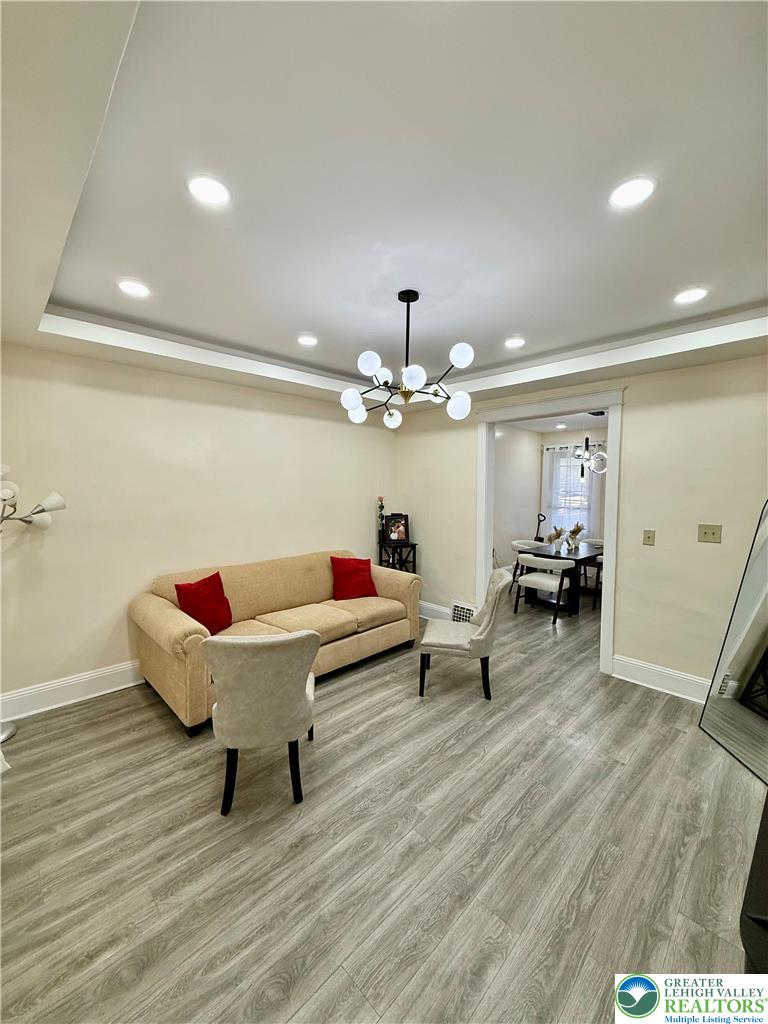 1025 Spring Street Bethlehem, PA 18018 - Photo 3 of 20 Recessed lighting and a modern chandelier illuminate the spacious living area.