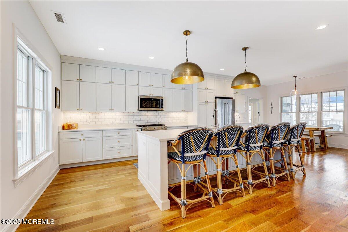 1713 Certainty Drive Point Pleasant, NJ 08742 - Photo 13 of 49 a kitchen with cabinets a sink dining table and chairs